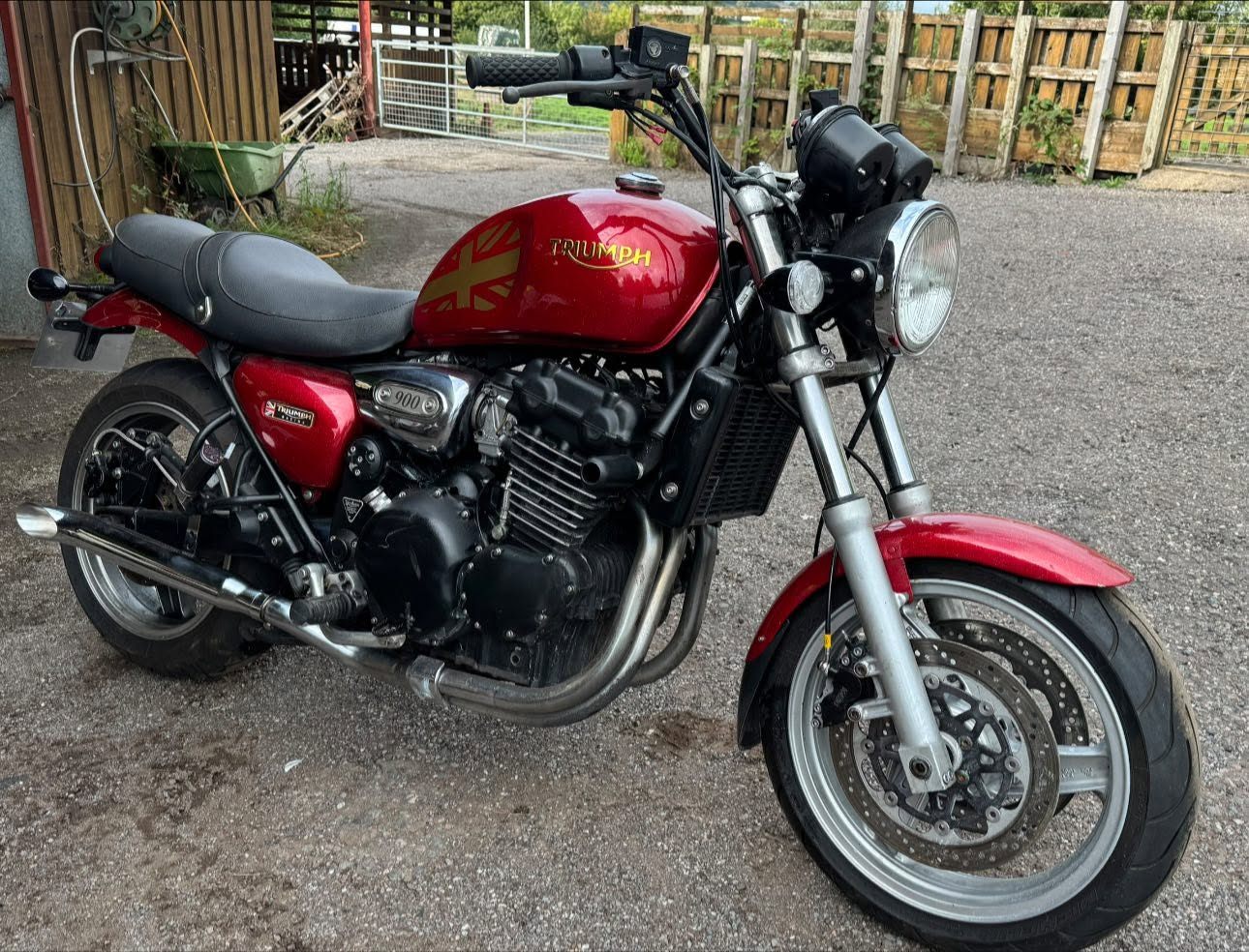 Red Triumph motorcycle after repair work