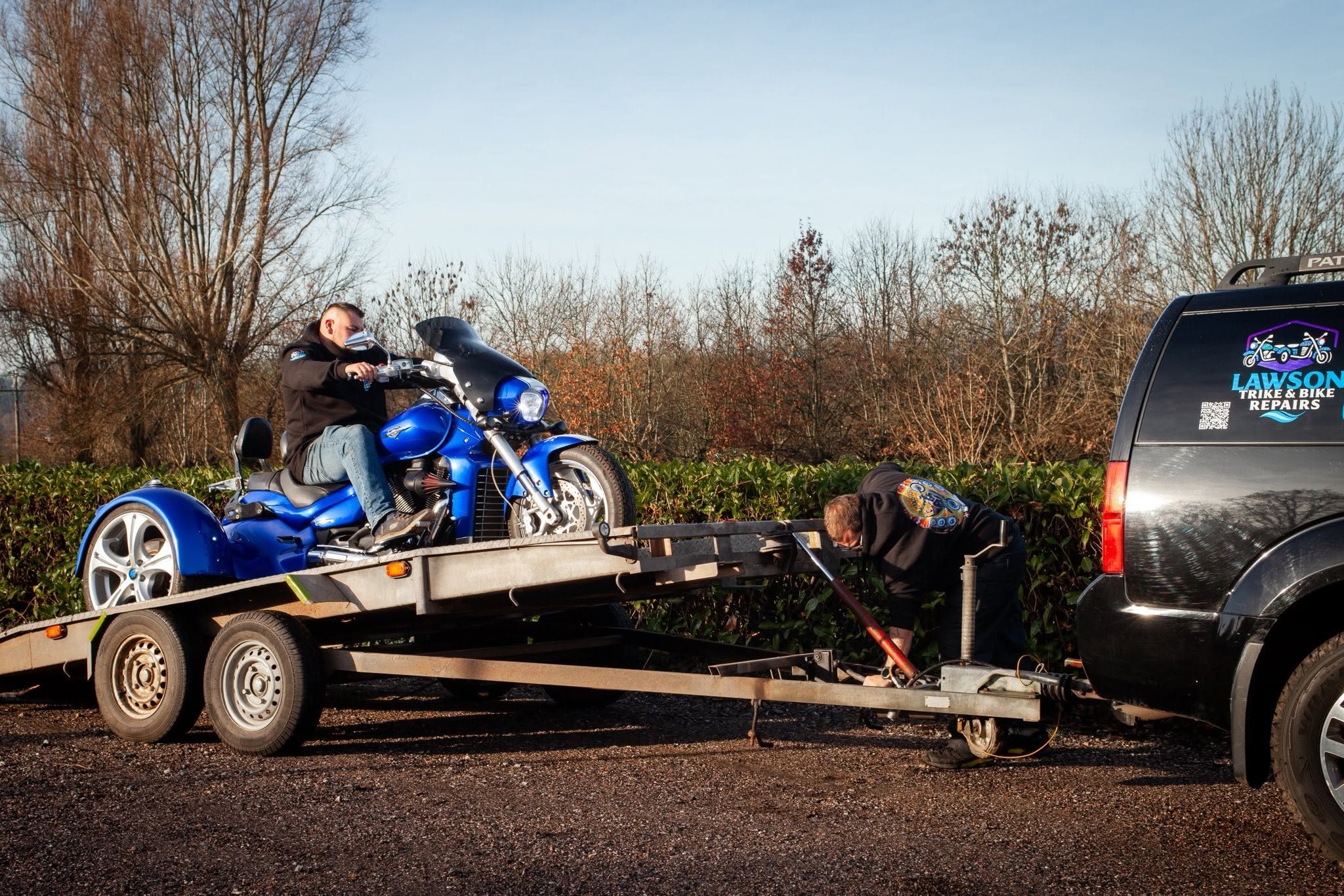 Blue trike being loaded onto the Lawson Trike and Bike Repairs trailer
